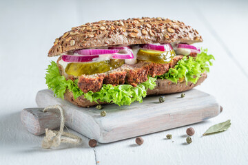 Savory pate sandwich with pickled cucumbers and lettuce for breakfast. - obrazy, fototapety, plakaty