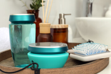 Hair care cosmetic products and brush on table indoors