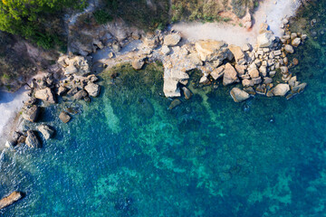 Fototapeta na wymiar Clear water on the beach with rocks, aerial view.