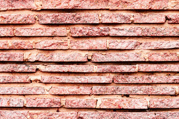 Texture of a brick wall with cracks and scratches which can be used as a background