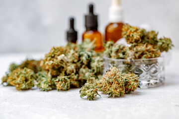 Hemp oil, Medical marijuana products including cannabis leaf, dried bud, cbd and hash oil over black wood background