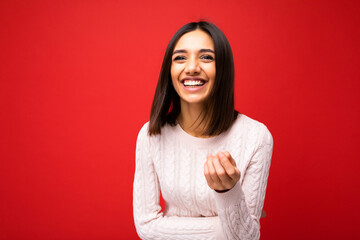 Photo of young positive happy smiling beautiful woman with sincere emotions wearing stylish clothes isolated over background with copy space