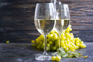 glass of white wine grapes on a concrete background