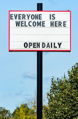 Exterior retail open sign during the pandemic restrictions illustrating equity.