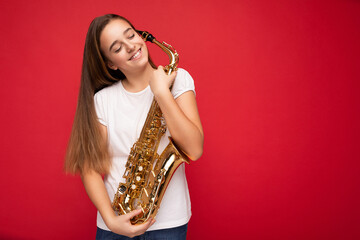 Shot of charming happy smiling brunette little female teenager wearing white t-shirt for mockup...