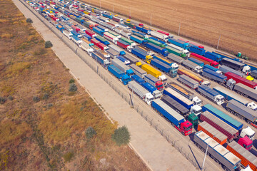 Fototapeta na wymiar Trucks in line at the loading terminal. Transportation of goods by cars.