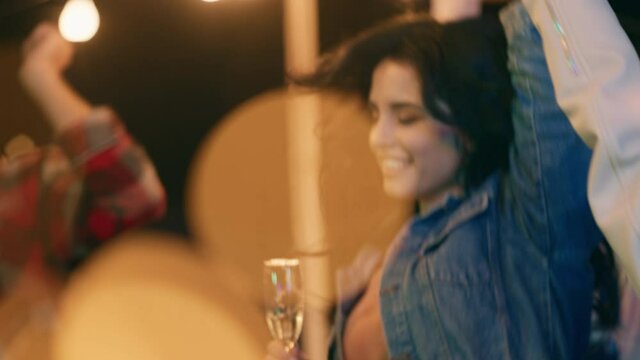 Smiling large young woman and her charismatic friends enjoy the time together on the rooftop of terrace they dancing and feeling great