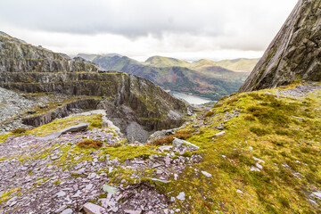 View over high slate quarry to lake and mountains, landscape.