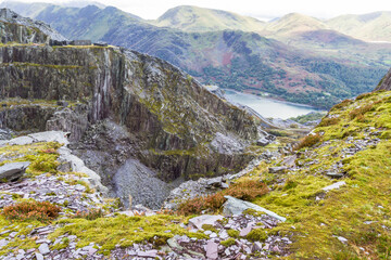 View over slate quarry to lake and mountains, landscape, Unesco Heritage Landscape.