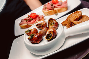 .Escargots with sauce and rye bread