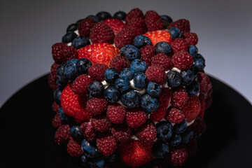 Cake with berries, blueberries, strawberries on a light background, close-up view. Summer berry cake concept