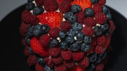 Cake with berries, blueberries, strawberries on a light background, close-up view. Summer berry cake concept