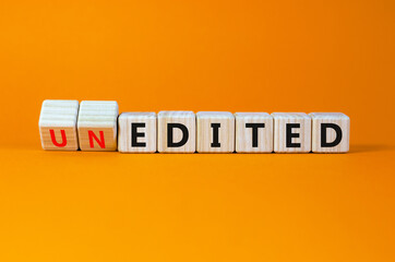 Edited or unedited symbol. Turned wooden cubes and changed the word unedited to edited. Business and edited or unedited concept. Beautiful orange background, copy space.