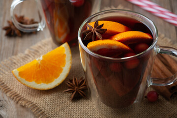 Glintwine with citrus and anise. Christmas and winter warming beverage on wooden background