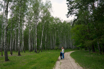 Happy loving mother and two children, son and daughter hiking in forest. Family walk in nature park. Summer camping.. Summer time camping.