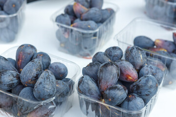Ripe juicy figs in a plastic container
