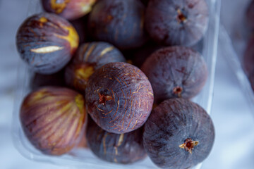 Ripe juicy figs in a plastic container