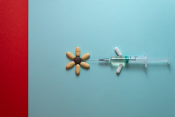 Antibiotic syringe with medicine on blue and red background