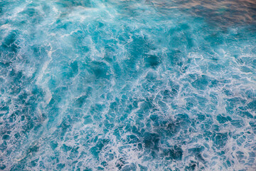 Fototapeta premium Deep blue stormy sea water surface with white foam and waves pattern, background photo texture