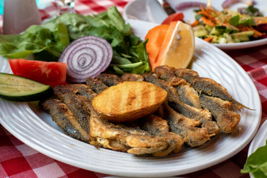 Close up fried mackerel with various garnishes