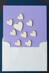 valentine's day hearts on lavender paper stuffed inside an envelope