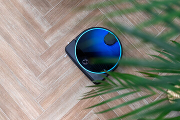 Robot vacuum cleaner in the interior, autonomous cleaning of the apartment with a vacuum cleaner,...