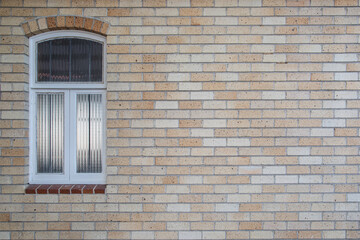 Fototapeta na wymiar Light Orange Church Brick Wall with White Painted Wood Window