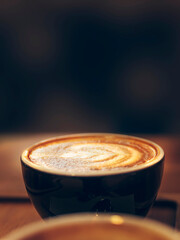 Coffee mug with dark background as empty space. Morning drink