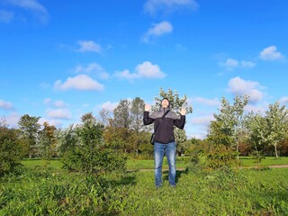 A man takes a sun bath in the early morning in autumn