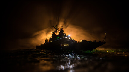 Silhouettes of a crowd standing at blurred military war ship on foggy background. Selective focus. © zef art