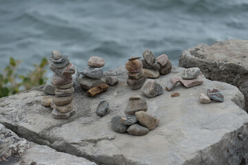 Fototapeta na wymiar piles of stones by water