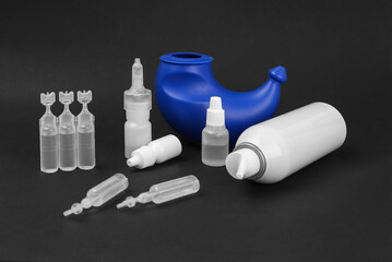 Different types of medical drops, nasal spray and nasal spray on black background. Sanitation of the nose, rinsing. Viruses. Diseases.