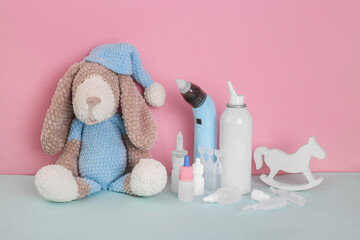 Dog toy, nasal aspirator, drops, nasal spray, mono doses, tablets on blue background with space to copy; fun Pediatrics concept; children's medicine