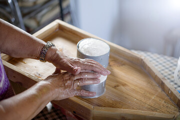 woman preparing homemade soft goat cheese