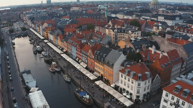 Aerial view of famous Nyhavn pier with colorful buildings and boats in Copenhagen, Denmark. The most popular and touristic place in Copenhagen.