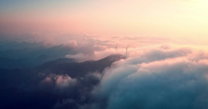 Aerial view of wind turbines or windmills farm field in industry factory with sea fog.