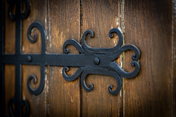 Decorating wooden gates with metal forged elements. Modern exteriors of private houses