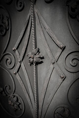 Vertical image of forged metal elements that adorn the gate