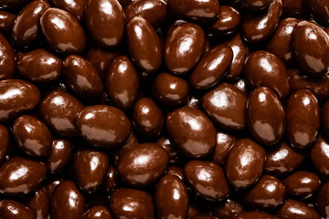 Dark chocolate covered almonds, isolated.
