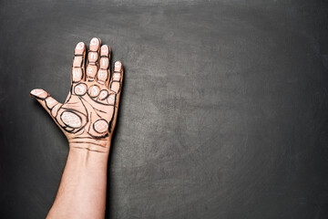 Close-up shot of person's left palm with drawn lines and chiromancy symbols. Concept of prediction...