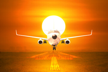Front view passenger aircraft takeoff on runway in sunset