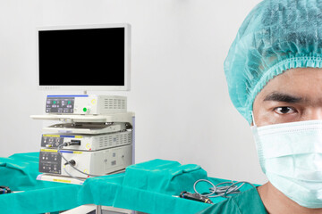 Fototapeta na wymiar Close up image half face of surgeon looking at camera and equipment tools in operating room