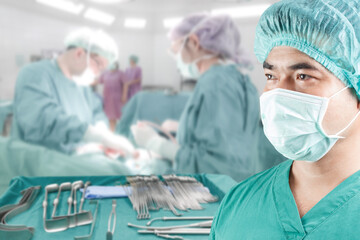 close up image of mature male surgeon with equipment tools for surgeons who need to operate a patient in an operation room arranged on a table for a surgery of surgeon in operating room - Powered by Adobe