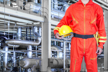 Engineer holding hard hat in action for working with equipments and machinery in a modern thermal power plant