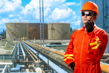 Engineer with radio communication for working at pipe line connection to oil tanks in petrochemical...