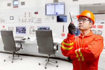 Technician use radio communication for command working at control room of a modern thermal power plant