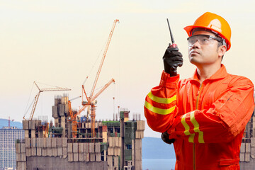 Technician with radio communication in action control working at high building construction site