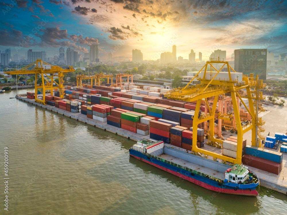 Wall mural aerial view of container loading in a cargo freight ship with crane to shore lift up loading export 