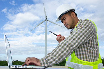 Engineer looking at tablet computer with radio communication in action for working at wind turbine...