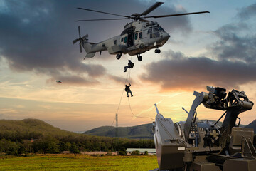 Anti Aircraft gun with military commando helicopter drops between are in flight for operation...